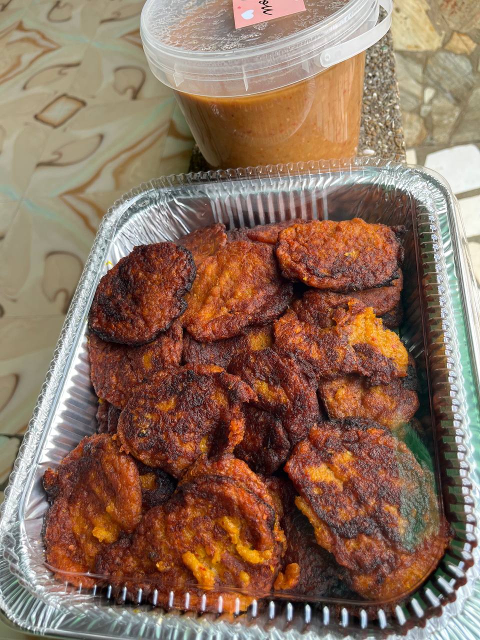 Pack of kaaklo with a bucket of bambara beans